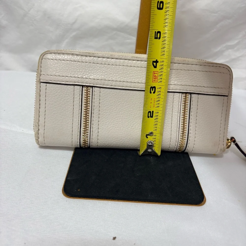 Michael Kors Moxley continental zip-around wallet in vanilla or cream leather.